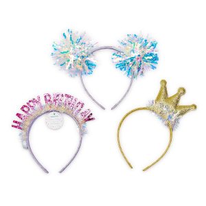 Three festive headbands: one with iridescent pom-poms, one with a "Happy Birthday" sign, and one with a gold crown.
