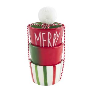 Three stacked ceramic bowls with red, white, and green stripes, topped with a pom-pom and the word "MERRY" written on one.