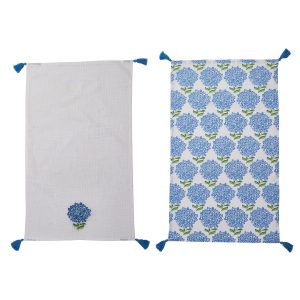 Two rectangular cloths with blue tassels; one has a single blue flower, the other has a blue floral pattern.