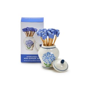 A ceramic jar decorated with blue hydrangeas holds blue-topped bamboo picks; matching box in the background.