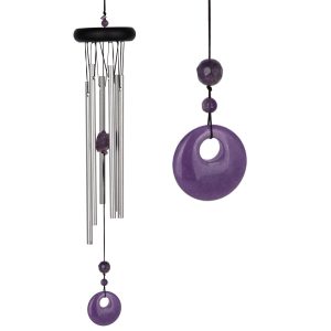 A metal wind chime with silver tubes and purple gemstone accents, including a round amulet at the bottom.