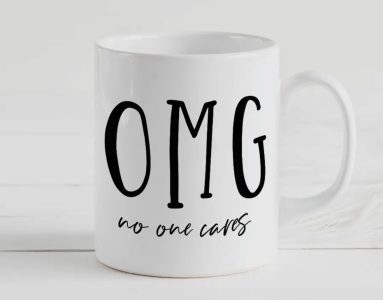 White ceramic mug with bold black text that reads "OMG" and smaller script below that says "no one cares.