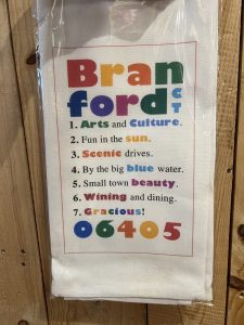 A towel lists "Branford CT" and highlights local features with colorful text, ending with the zip code 06405.