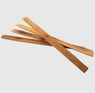 Several flat, rectangular wooden sticks are arranged in a loose, overlapping pile on a plain white background.