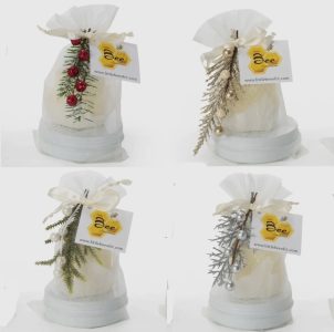 Four gift bags decorated with festive ornaments, each with a "Bee" tag and arranged in a grid on a white background.
