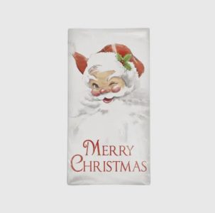 A white napkin with a winking Santa Claus illustration and the text “Merry Christmas” in red letters.