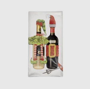 Two wine bottles dressed in festive holiday elf and Santa outfits, with a corkscrew lying beside them.