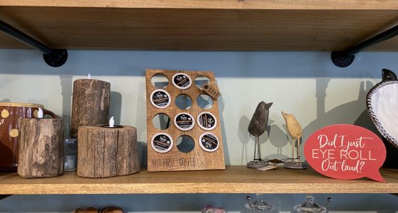 Wooden shelf with rustic decor items, a coffee pod holder, and a sign saying, "Did I just EYE ROLL Out loud?.