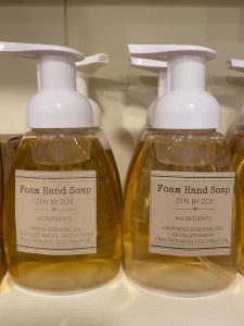 Two bottles of foam hand soap labeled "Zen by Zoe" with ingredient lists visible on a store shelf.