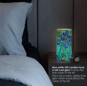 A bedside table lamp with a blue-white LED glow illuminates a cylindrical vase featuring colorful floral artwork.
