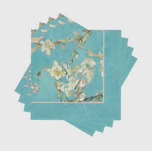 Four napkins with a blue background and white flowering almond branch design inspired by Van Gogh’s artwork.