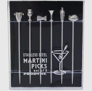A set of six stainless steel martini picks with different drink-themed toppers in a clear display case.