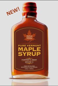A bottle of Pure Vermont Maple Syrup with a "NEW!" label, containing 6.8 oz, from Maple Craft Foods.