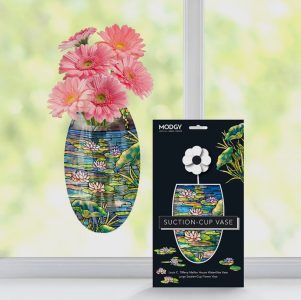 A suction-cup vase with pink flowers sticks to a window; packaging with lily pad design is displayed in front.