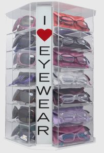 Rotating display stand with multiple pairs of eyeglasses and a sign reading "I ♥ Eyewear.