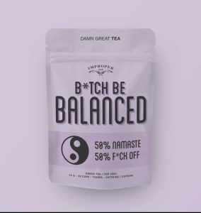 A resealable tea pouch labeled “B*tch Be Balanced” with yin-yang symbol and bold text on a light purple background.