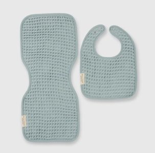 A textured blue baby burp cloth and matching bib are displayed on a light background.